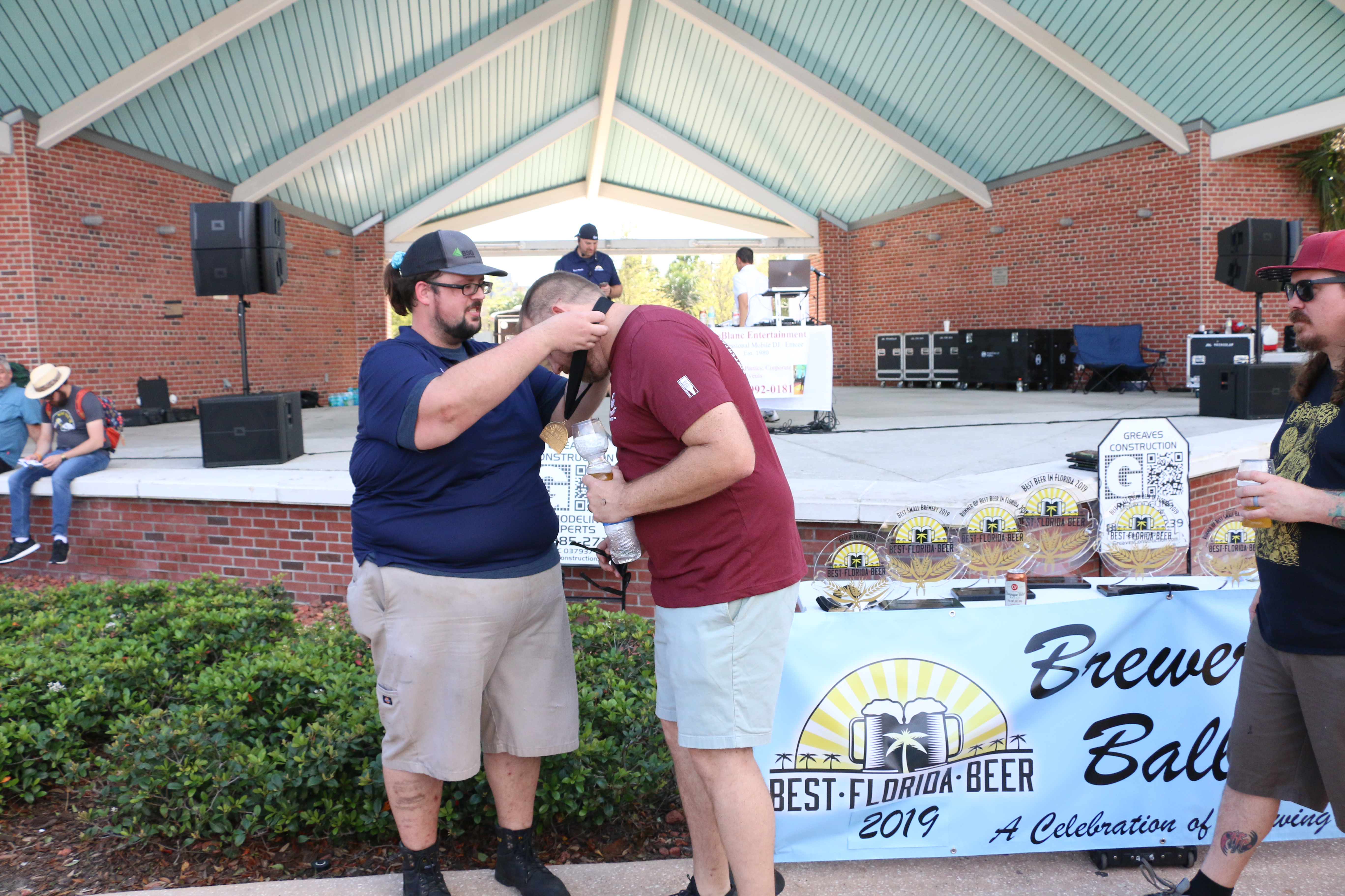 Coppertail Brewing's Casey Hughes accepts a medal at 2019 Brewers Ball Best Florida Beer Competition