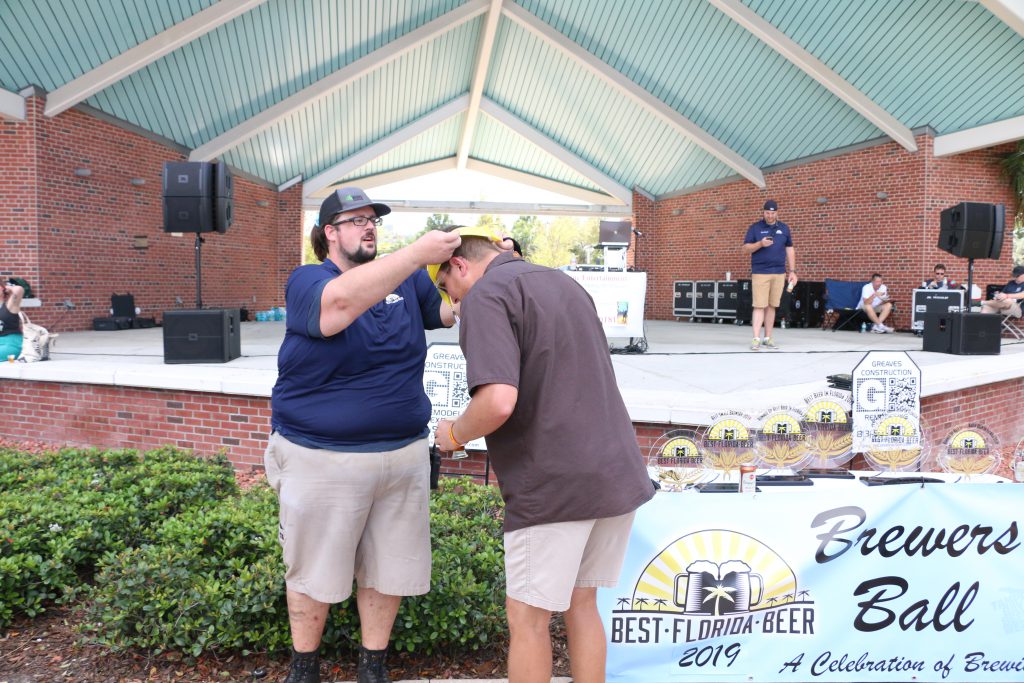 Halpatter Brewing's Jonny Frazier accepts a medal at Best Florida Beer Brewers Ball 2019