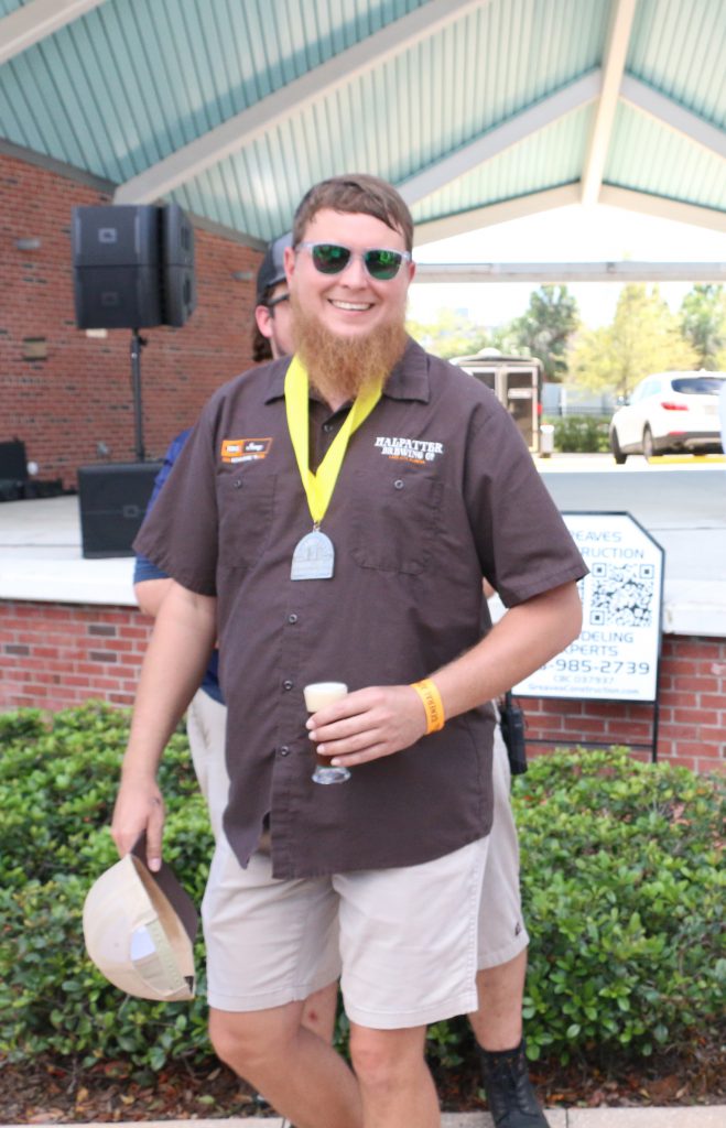 Halpatter Brewing's Jonny Frazier accepts a medal at Best Florida Beer Brewers Ball 2019