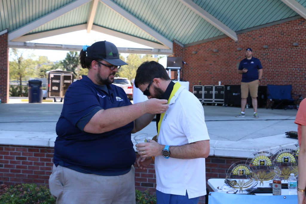 Swamp Head Brewery's Luke Kemper accepts a medal at 2019 Best Florida Beer Brewers Ball 2019