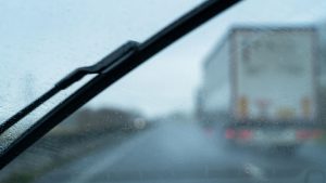 Car windshield looking at a truck