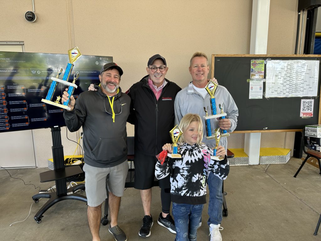 Men holding trophy